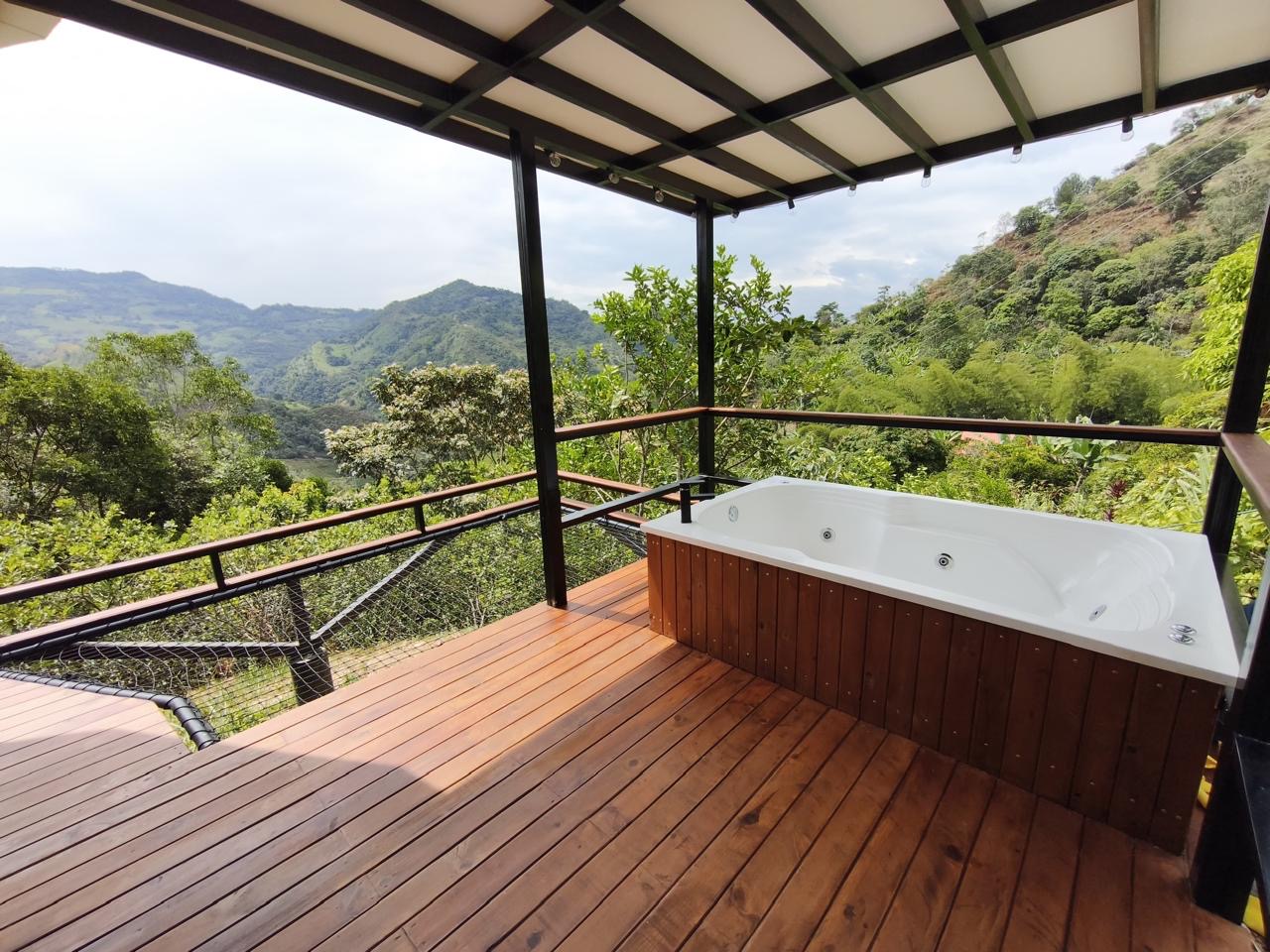 The private jacuzzi overlooking green mountain scenery